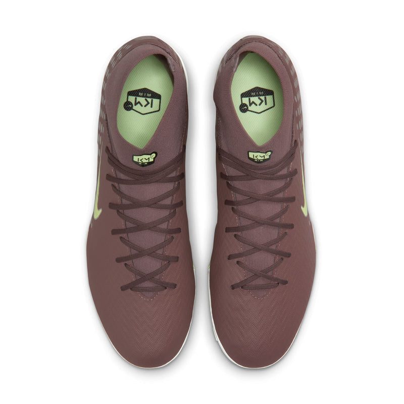 Pair of plum soccer cleats showing lace-up front and green-lined tongue label.