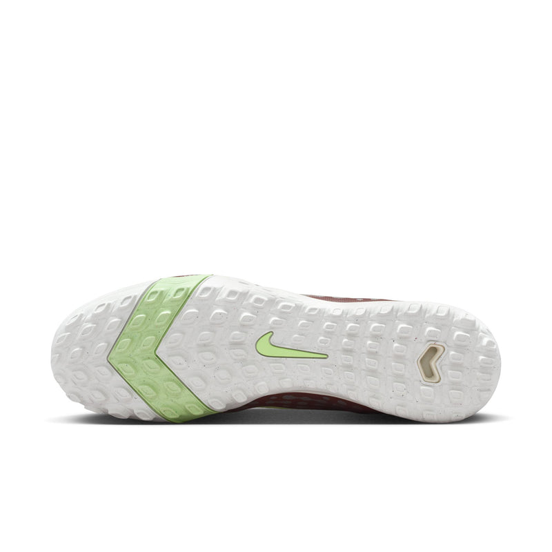 Turf soccer cleat outsole view: white tread with neon green heel section.