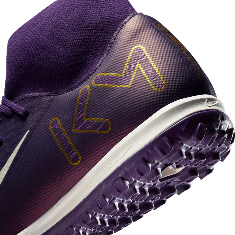 Men's purple TF football boot close-up, outsole tread and gold line pattern detail