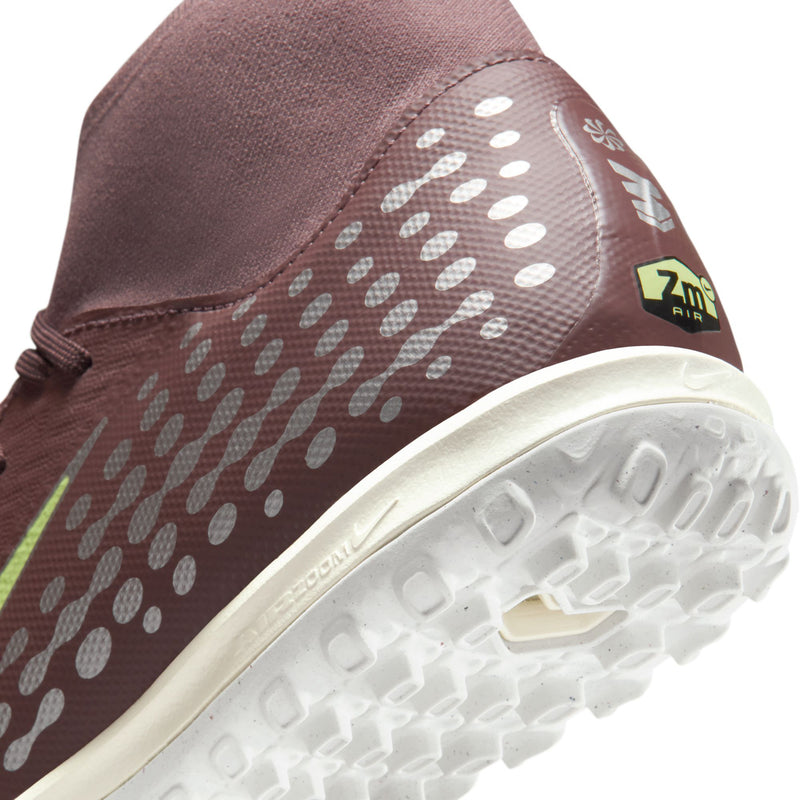 Close-up of plum upper, dotted side pattern, and white rubber outsole tread.