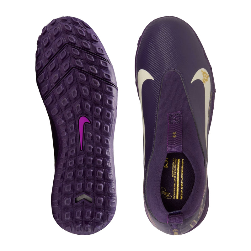 Youth purple TF soccer cleats, textured rubber outsole with stud pattern, sockless view.