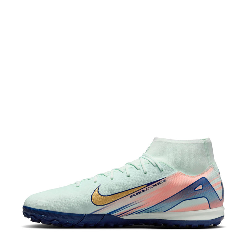 Men's turf soccer cleat side view in light mint with gold swoosh and colorful panels