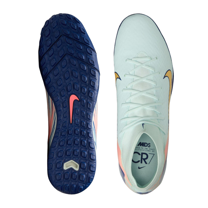 Men's turf cleat outsole and insole views, dark blue tread with mint upper