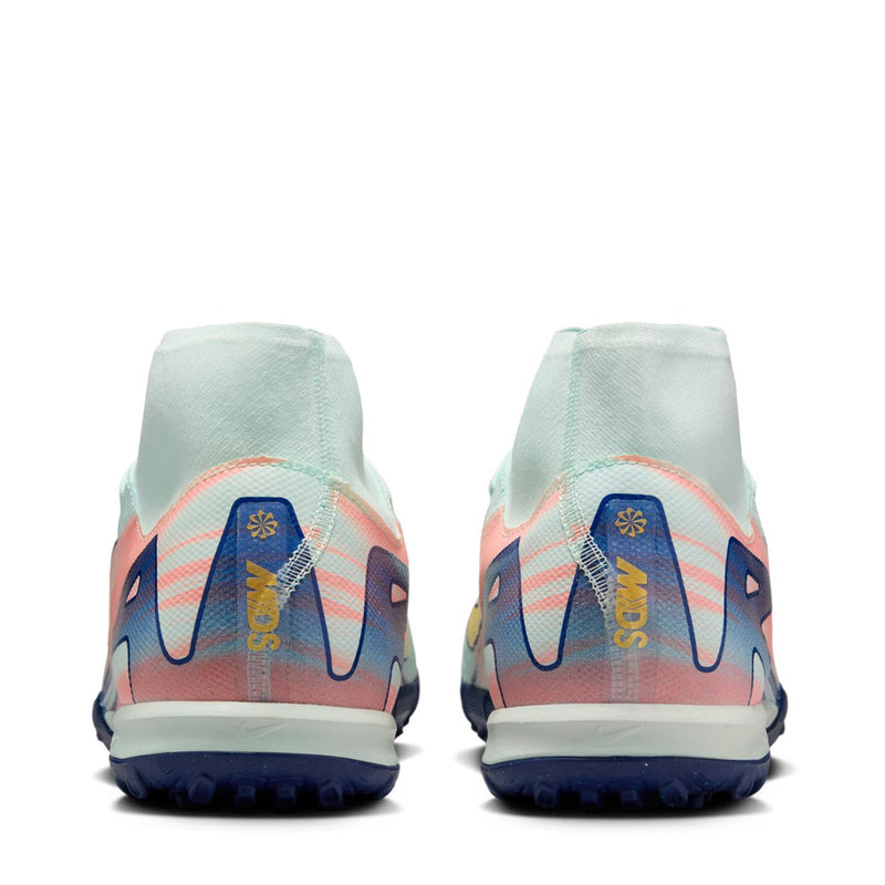 Men's turf cleats heel view in light mint with blue heel logo and pink accents
