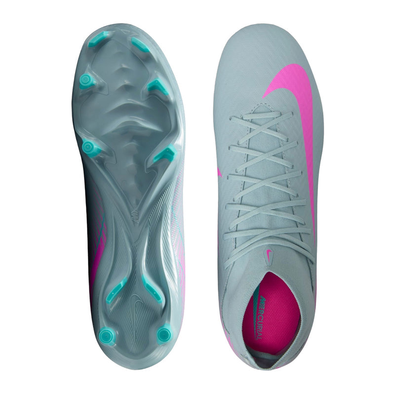 Pair of light blue men’s soccer cleats: pink heel lining and white laces