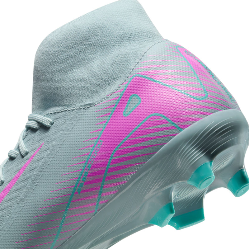 Side close-up of light blue men’s soccer cleat with pink graphic and teal studs