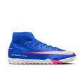 Men's blue TF soccer cleats with white and pink swoosh accents and molded studs