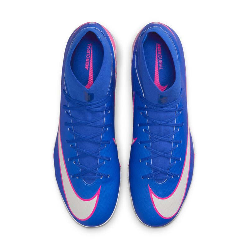 Pair of blue soccer cleats with white midsoles and pink swoosh side panels