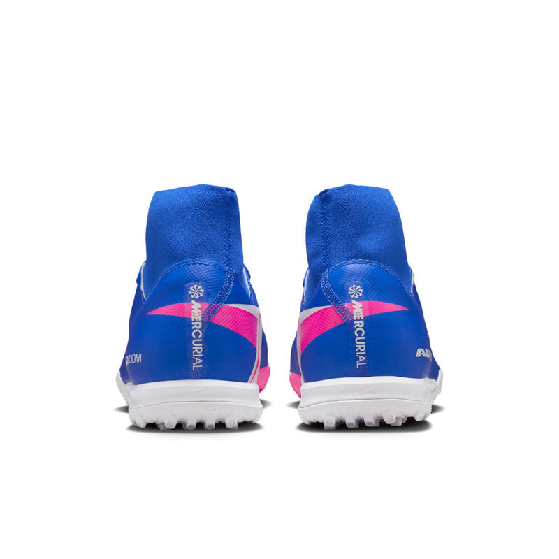 Men's blue TF soccer cleats with pink heel accents and white outsole