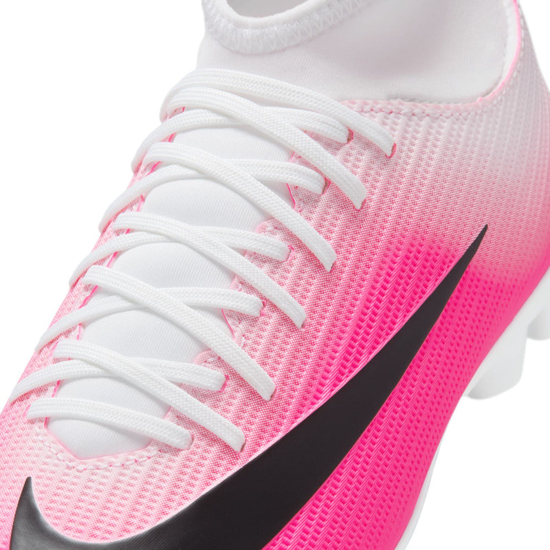 Close-up youth soccer cleat upper with pink mesh texture, white laces, and black logo