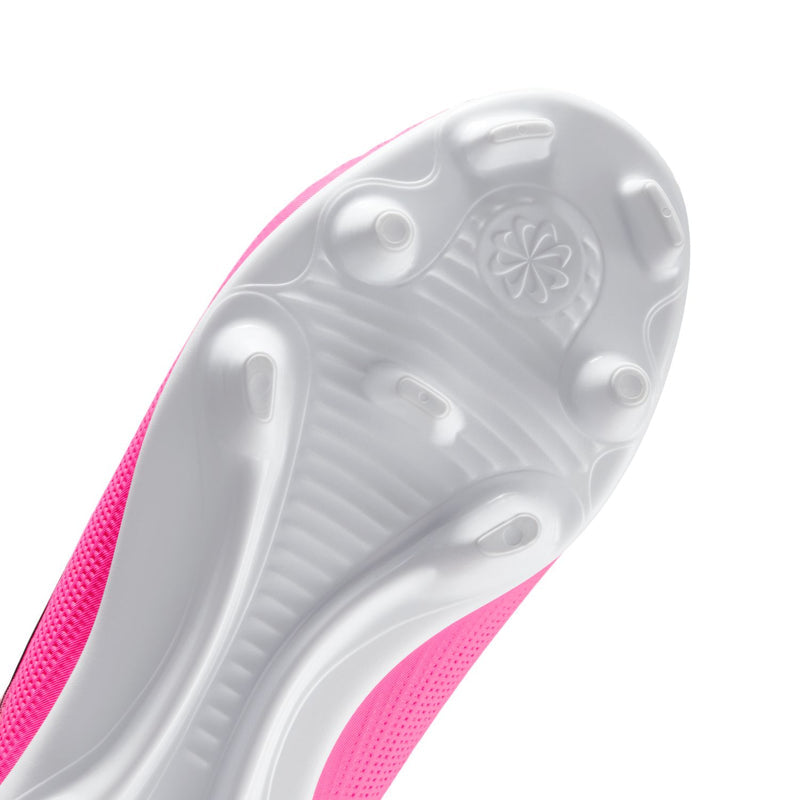 Close-up youth soccer cleat outsole with white traction pattern and pink edge