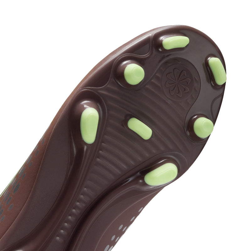Youth soccer cleat bottom view with neon green studs on dark brown outsole