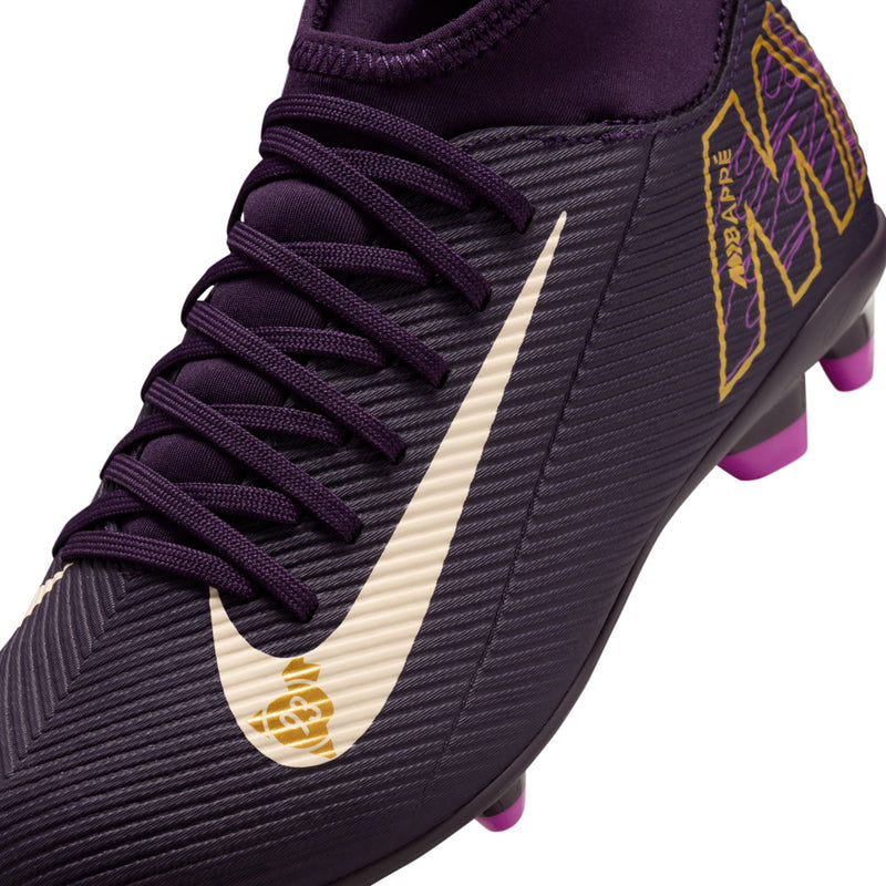 Close-up youth purple soccer cleat laces and white swoosh with yellow KM side logo