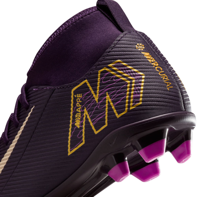 Youth purple soccer cleat side close-up with yellow KM pattern and white swoosh detail