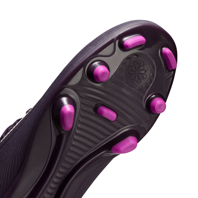 Youth purple soccer cleat outsole close-up with pink studs and molded traction pattern