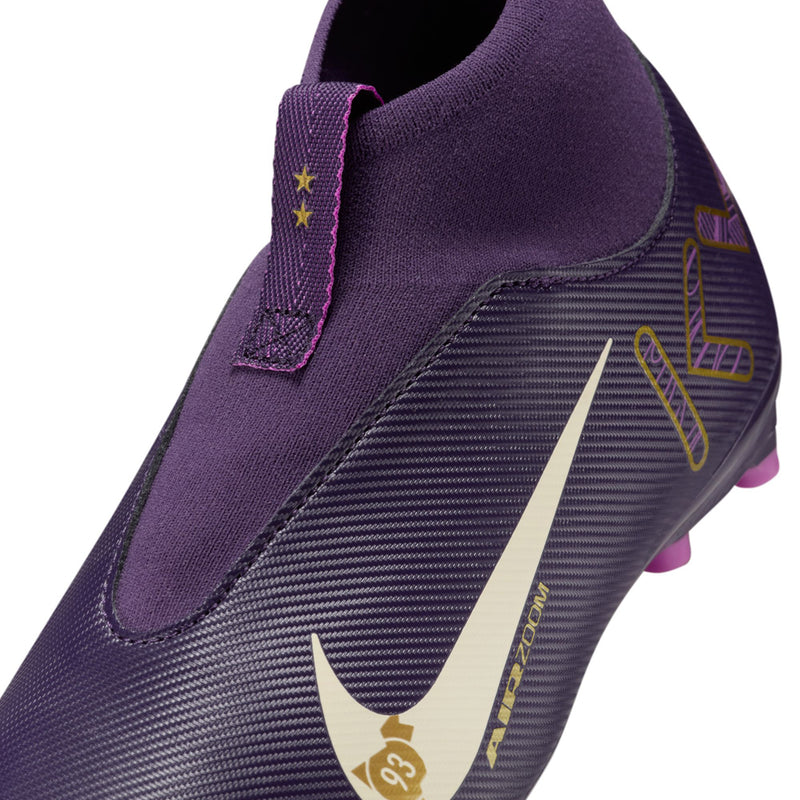 Youth purple soccer cleat close-up of side panel, white swoosh, pink TF studs