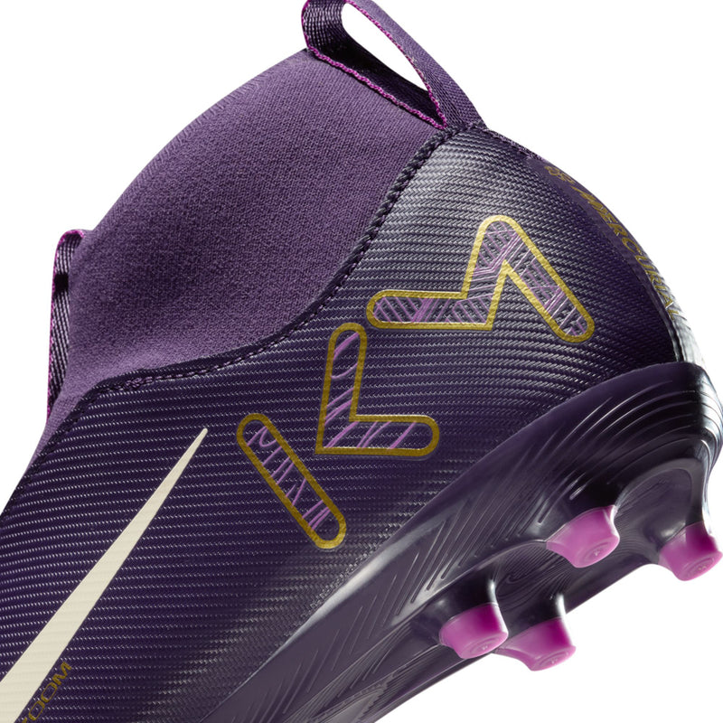 Youth purple soccer cleat close-up, white swoosh, gold graphics, pink TF studs
