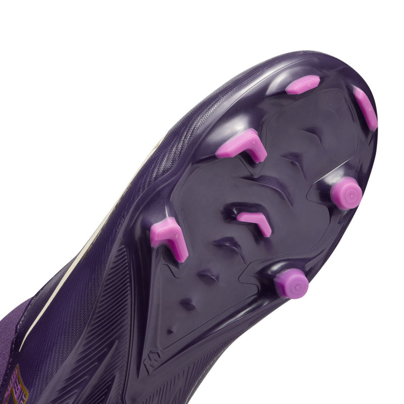 Youth purple soccer cleat outsole close-up with pink molded studs and tread