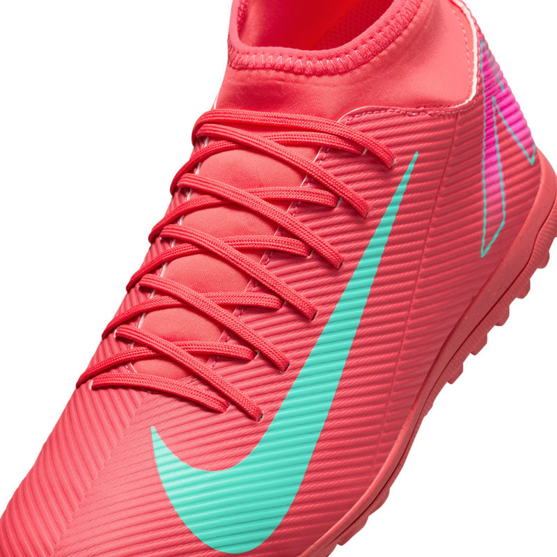 Men's red turf soccer shoes close-up of laces and turquoise swoosh stripe