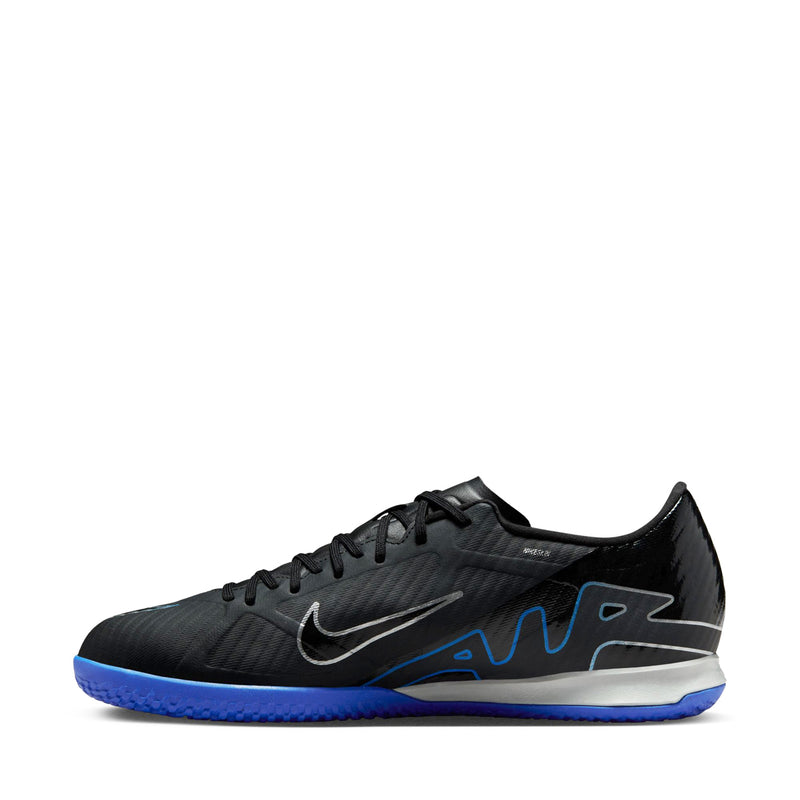Black lace-up soccer shoes with swoosh and blue graphic accents, low-cut profile