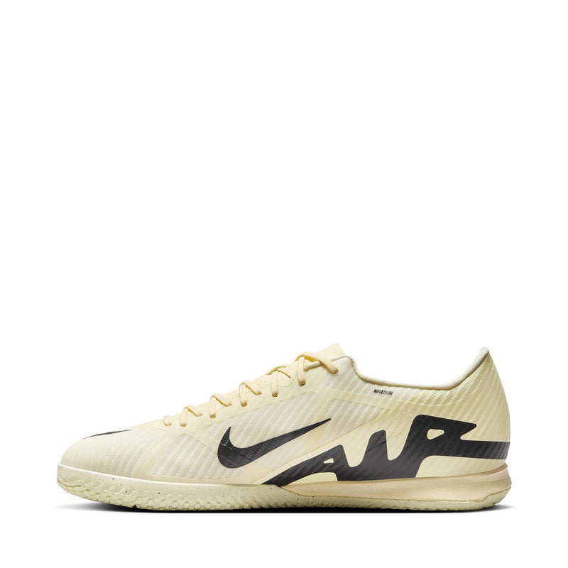Men's cream soccer cleats, side profile, black Swoosh and textured upper