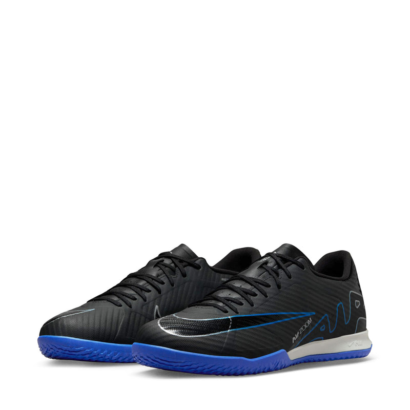 Black and blue lace-up soccer shoes with white/gray heel panel and textured pattern