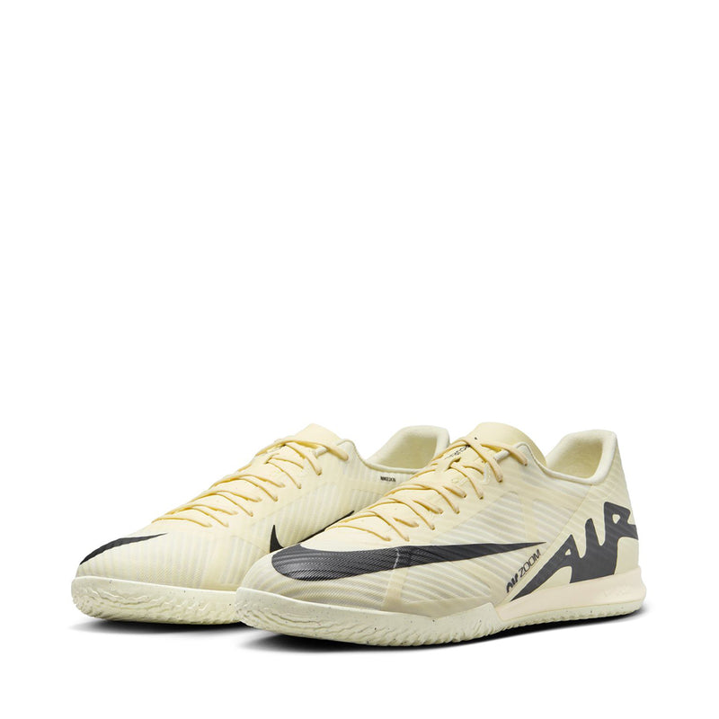 Pair of men's cream soccer cleats with black accents and lace-up uppers