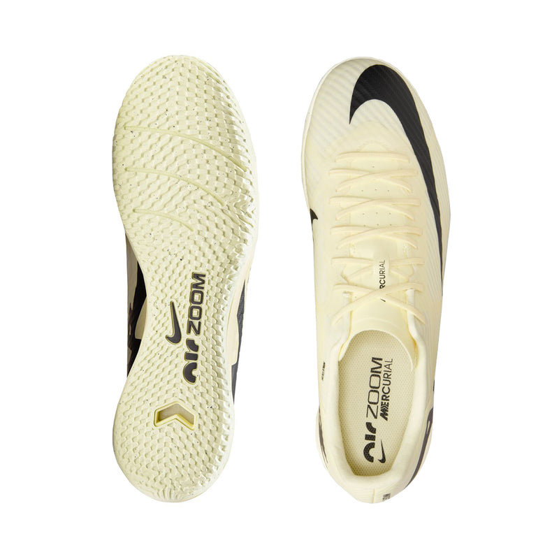 Men's cream soccer cleats showing rubber outsole and heel, black side detailing