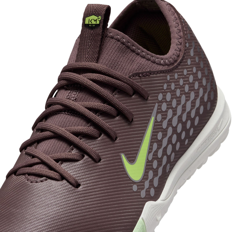 Close-up of youth plum lace-up turf soccer cleat with neon green swoosh logo
