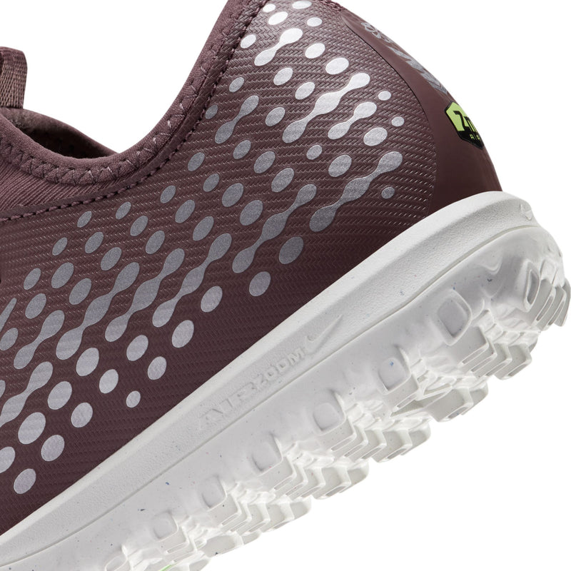 Close-up of youth plum cleat side with dotted texture and white outsole traction
