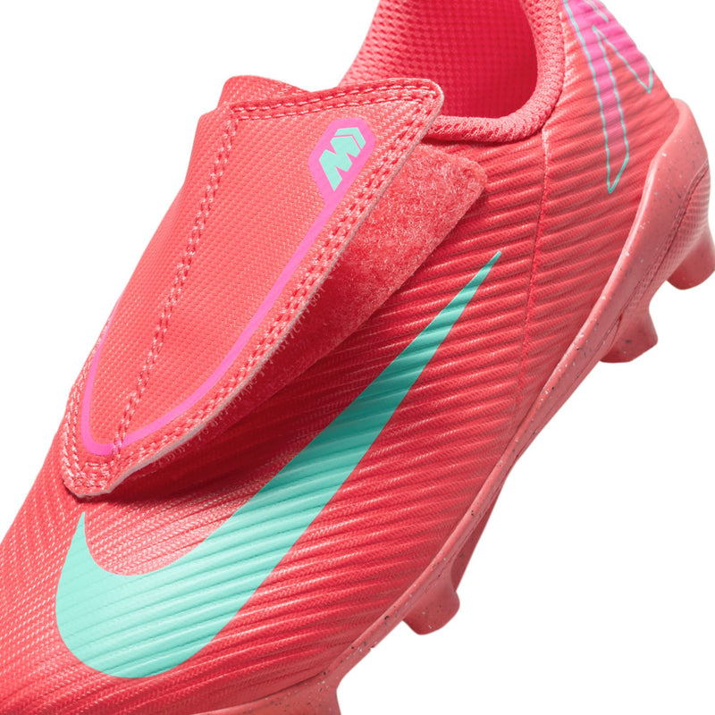 Kids red cleat upper close-up with teal swoosh, textured knit, stitched collar