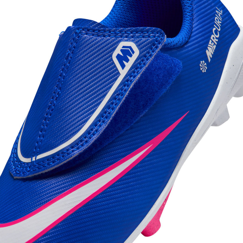 Kids' blue slip-on soccer cleat with pink swoosh stripe and white midsole