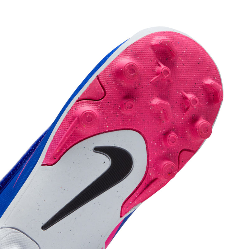 Kids' pink outsole soccer cleat with black Nike swoosh and white molded studs