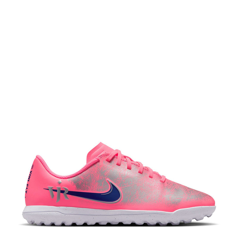 Youth low-cut turf soccer cleat, pink upper with dark blue swoosh and lace-up front.