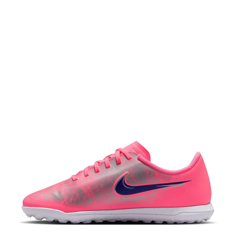 Youth turf soccer cleat, pink upper with dark blue swoosh, angled side view and laces.