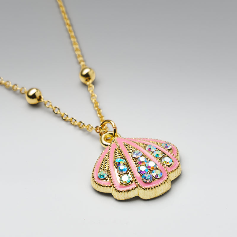 Necklace with a pink and gold pendant on a light gray background