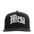 Black baseball cap with white front logo and curved brim