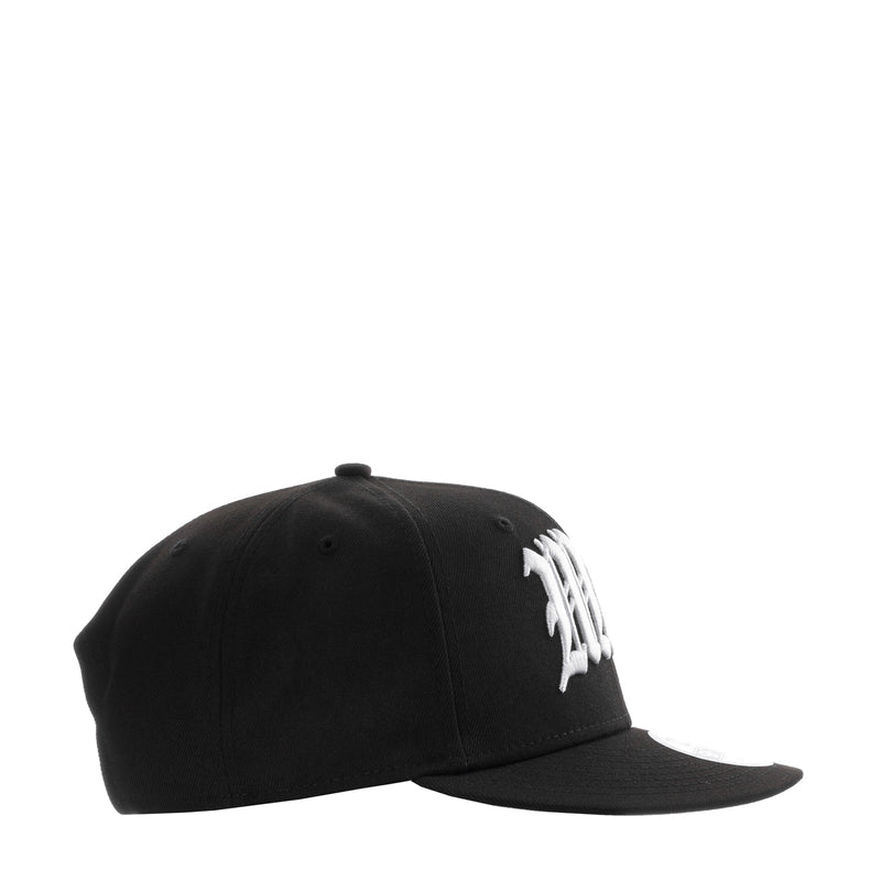 Black baseball cap side view with white stitched emblem on crown