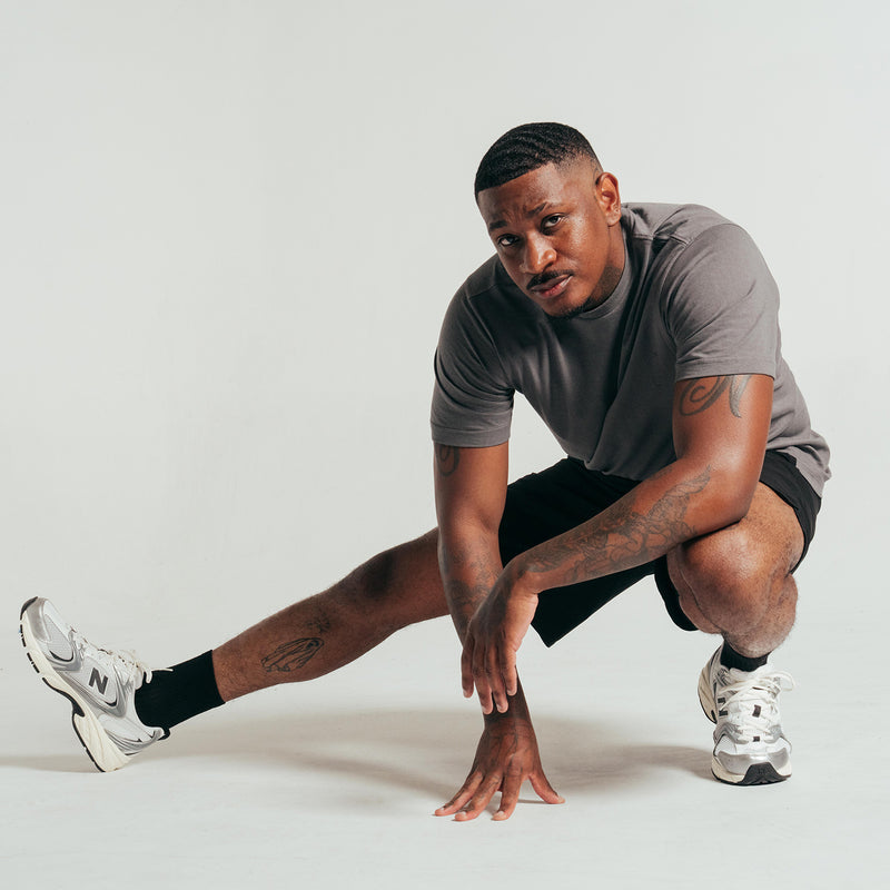 Black woven men's shorts with elastic waistband, above-knee hem and side seams.