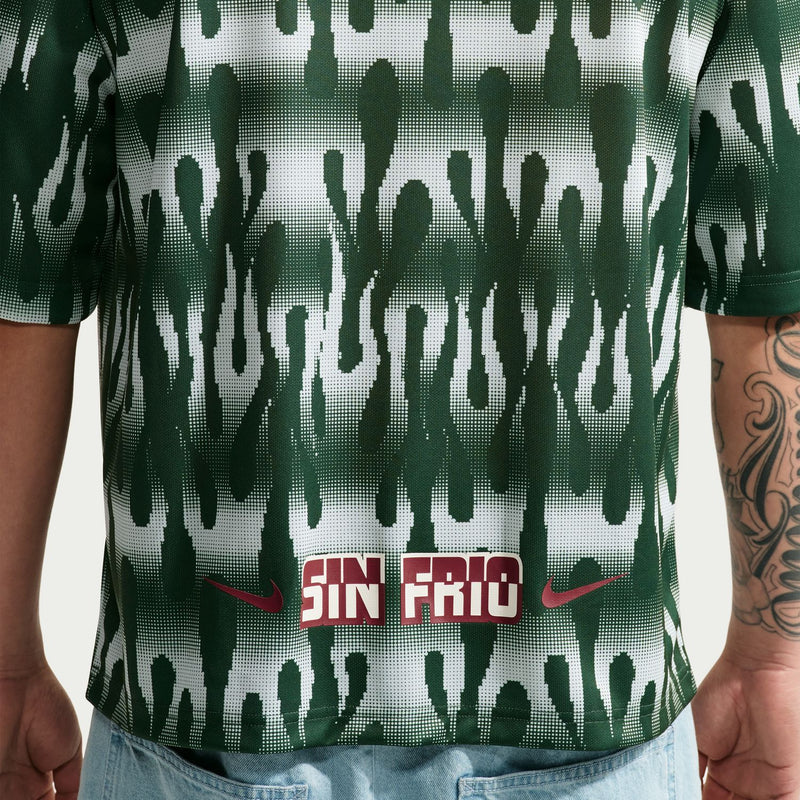 Men's Mexico goalie jersey close-up: dark green drippy pattern with red "SIN FRIO" graphic
