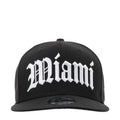 Black baseball cap with large white Miami graphic on the front