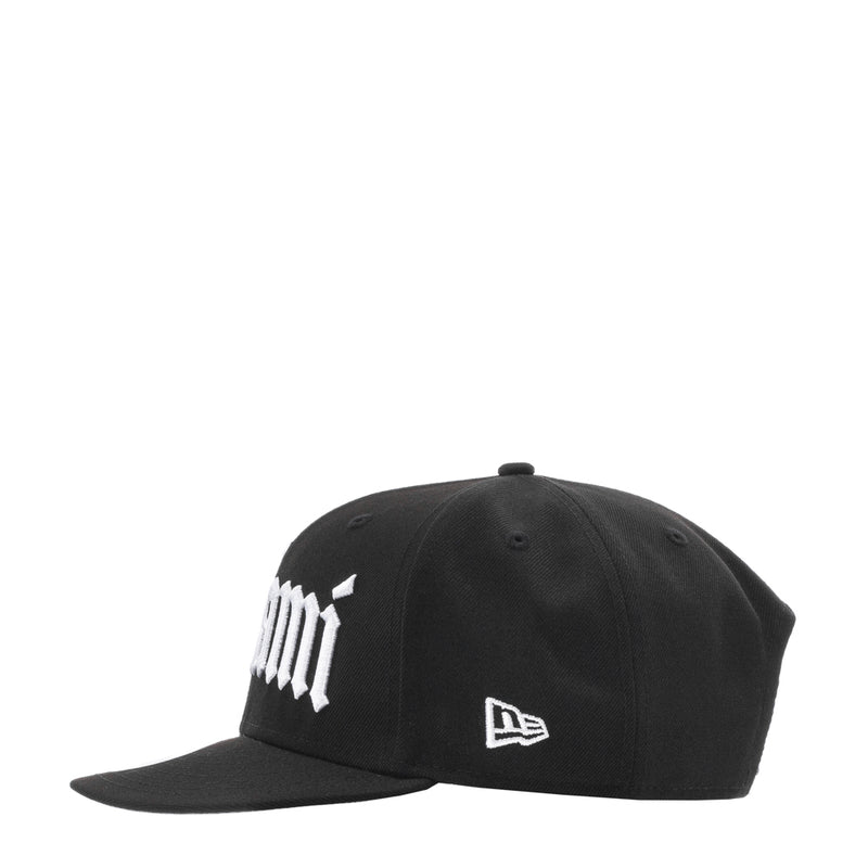 Black baseball cap with white logo text and small New Era flag