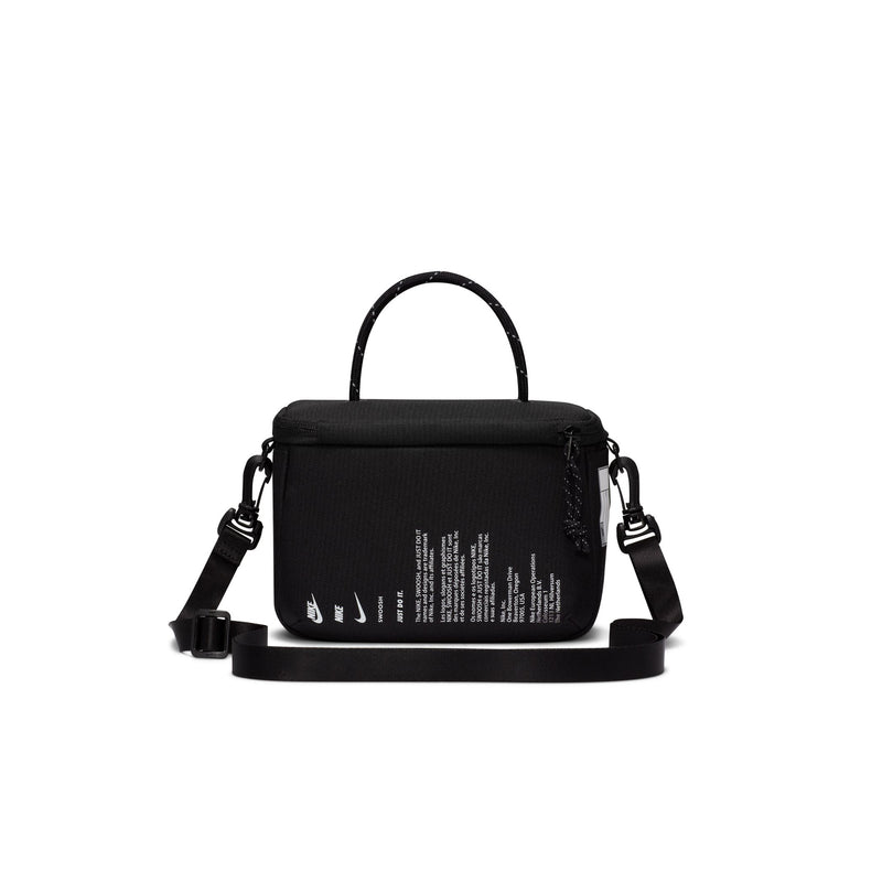Black mini crossbody bag back view with small printed text and top handle