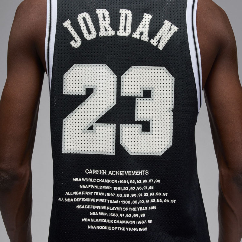 Men's black basketball jersey close-up: white No. 23 with Jordan lettering and stats text