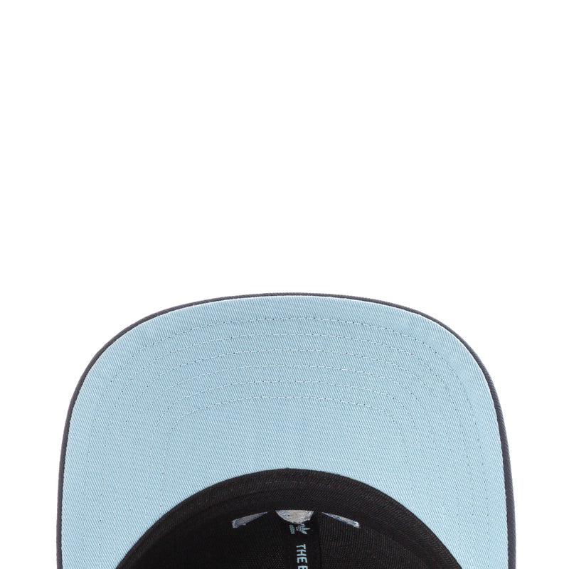 Light blue underside of snapback cap brim with stitched Adidas label