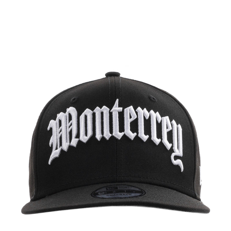Black baseball cap with large white script front logo and curved brim