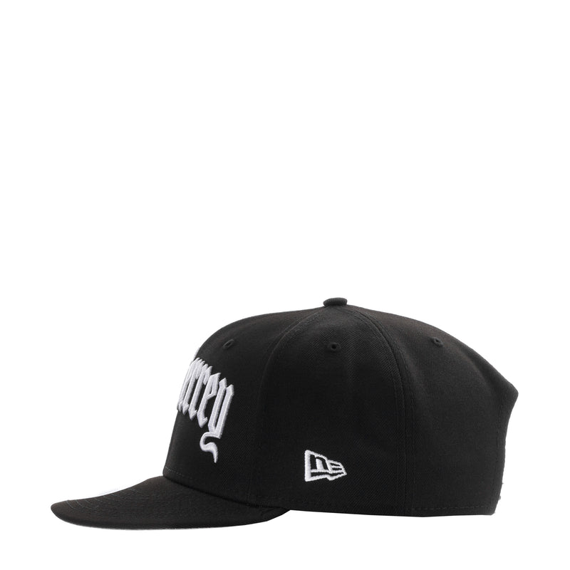Black baseball cap with white side script logo and New Era flag