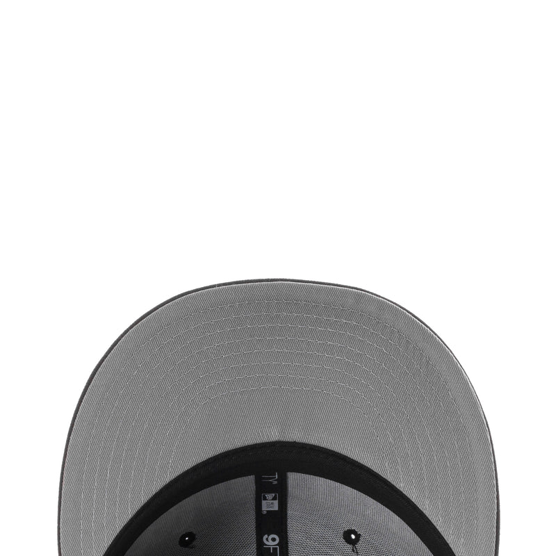 Black baseball cap with gray underside brim and stitched panel