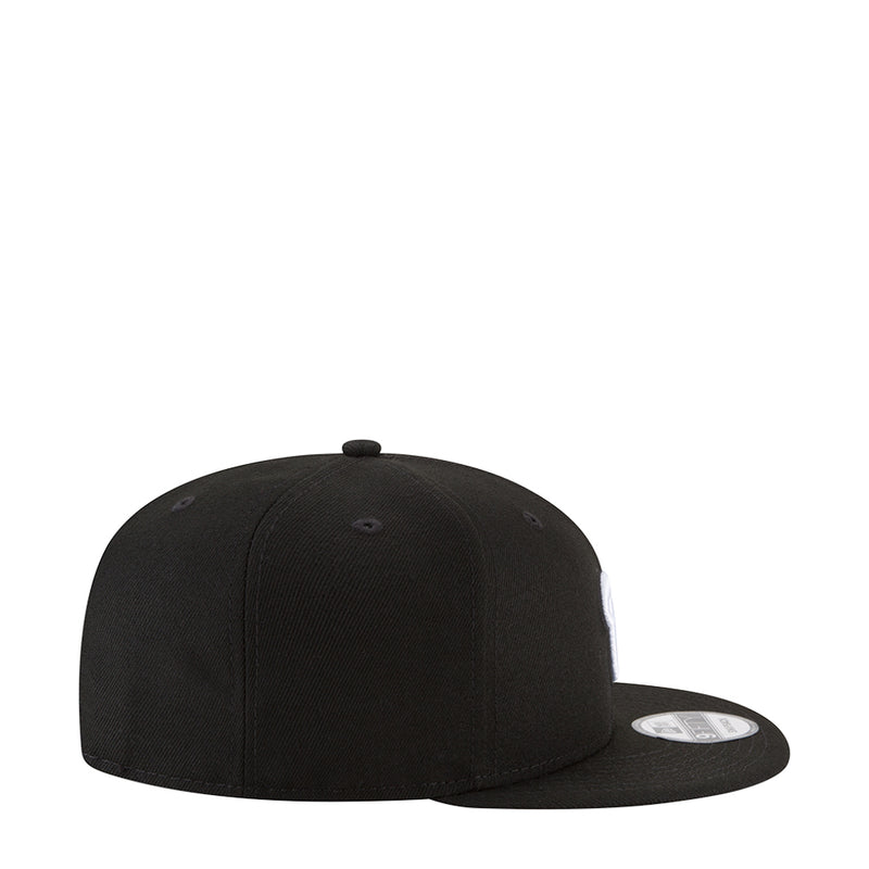 Black baseball cap with stitched panels and small front button