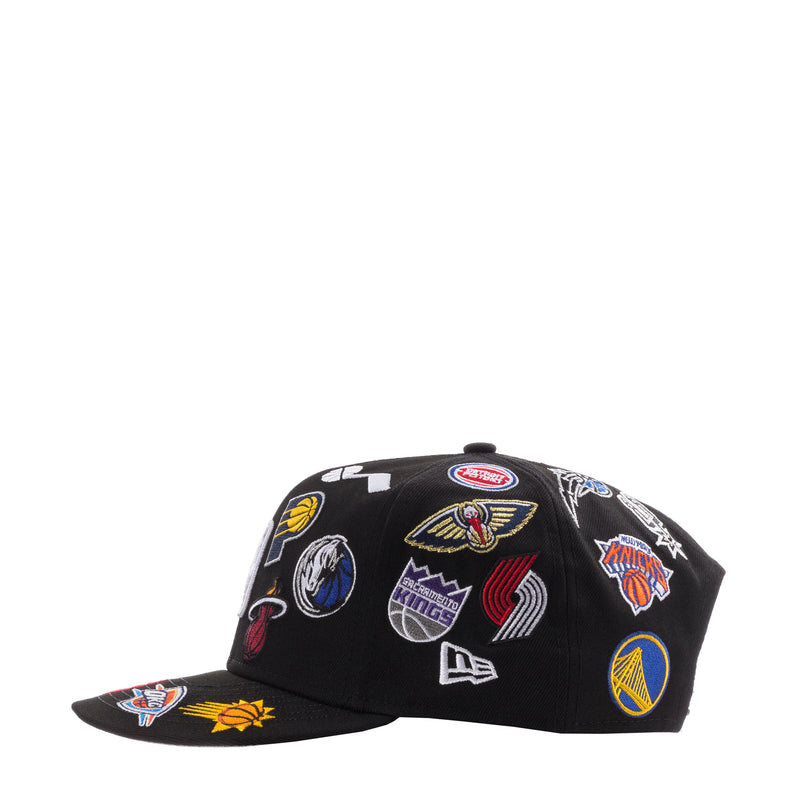 Black NBA team logo cap with multiple patches across the crown and curved brim